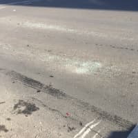 <p>Smashed glass and tire tracks on the ground near where McMahon was involved in a crash.</p>