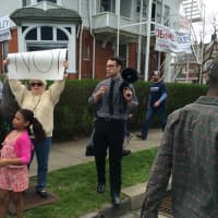 <p>Elliott Abbotts, center, uses a megaphone to get his message across outside a rally for Republican presidential hopeful Donald Trump in Bridgeport.</p>