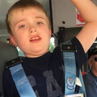 <p>Mikey Schwing of Ridgewood arrives home from school on Wednesday. His thermometer reads the temperature on the bus provided by the district.</p>