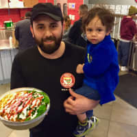 <p>Jaffar Wahdat with son, Ali, in Juicy Platters Hackensack. He is holding grilled chicken over sautéed greens: Green Blast® is sautéed Kale, Broccoli, Spinach &amp; Cilantro in Extra Virgin Olive Oil.</p>