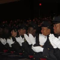 <p>Some of the newest graduates of the Westchester County Police Academy applaud of their fellow officers on Friday during ceremonies at SUNY Purchase.</p>