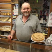 <p>Varrelmann&#x27;s Co-Owner Michael Fencik holds an apple crumb, another highlight of the bakery. Fencik said he typically recommends the apple crumb when customers are looking for a food to bring to a special occasion.</p>