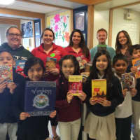 <p>Madison School third-graders in Bridgeport hold up the free books they&#x27;ll take home, thanks to a book drive at Sacred Heart University of Fairfield.</p>