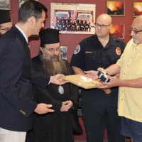 <p>Chios Mayor Manolis Vournous presents gifts to Ridgefield Council President Russell Castelli.</p>