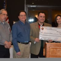 <p>Michael Lauzon, Greg Matera and George Ribellino present a check to Katie Marinelli from Homes for the Brave on behalf of the Sword &amp; Shield Golf Charity Golf Classic Committee.</p>
