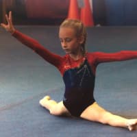 <p>Darien Level 3 gymnast Ava Telgheder hit a perfect split in her floor routine at the New England Invitational in Glastonbury.</p>