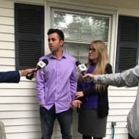 <p>Joel Colindrés, 33, and his wife, Samantha, 35, a U.S. citizen, hold hands as they speak to the media on Monday at their New Fairfield home. They have two U.S.-borne children: 6-year-old Preston and 2-year-old Lila.</p>