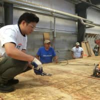 <p>Citi volunteers help build walls Friday for a new Habitat for Humanity home in Bridgeport.</p>