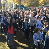 <p>Katonah resident Maria Colarco (in red) leads the Hillary Pantsuit Flashmob.</p>