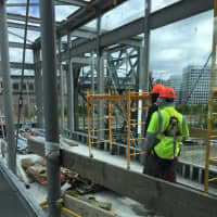 <p>Construction crews work on the new skybridge at the Stamford train station Monday.</p>