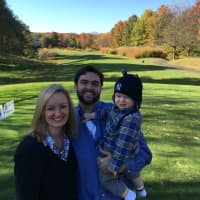<p>Jared and Jessica Spingler with baby Liam at a charity golf outing for their family on Oct. 26. Jared has been staying home with Liam while Jessica goes to work part-time, earning 60% of her full-time salary.</p>