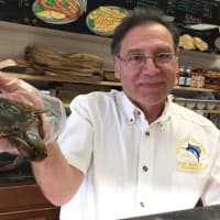 <p>Ciravolo and a soft shell crab — one of the few that remain in the store.</p>