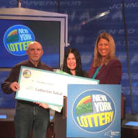 <p>Catherine Sakal, an accountant from Dutchess County, collects the $3.3 million after-tax balance of her $5 million Lottery scratch-off ticket purchased Jan. 4 in Rhinebeck. She is shown with her husband, William, as Yolanda Vega presents the check.</p>