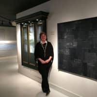 <p>Holly Sutton-Darr stands between two of the unique headboards at I.M. Smitten in Trumbull.</p>
