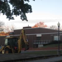 <p>A bulldozer and temporary orange fences surround Port Chester Middle School and the Port Chester-Rye Union Free School District offices on Tuesday Oct. 31 after a concrete panel collapsed smashing windows at the school on Oct. 26, prompting repairs.</p>