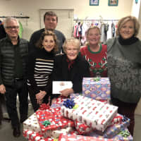 <p>Bedford resident Glenn Close and colleagues provide donations to families in need during the holiday season</p>
