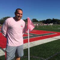 <p>Coach John VanSoest made pink corner flags for the Breast Cancer Awareness game.</p>
