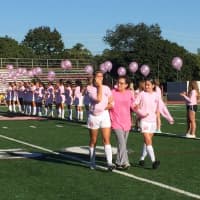 <p>Fair Lawn soccer players wipe tears from their eyes as they walk survivor Bearn Vargas across the field at the ceremony Thursday.</p>