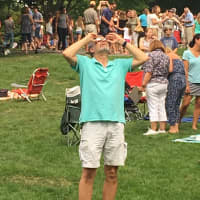 <p>One man has his eyes on the sky to check out the eclipse — but no one else in Ballard Park in Ridgefield seems to notice!</p>