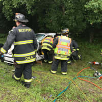 <p>Westport Firefighters work to free someone trapped in a car after a three-car crash on the Sherwood Island Connector.</p>