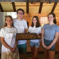 <p>Darien&#x27;s Jane Peters-Mossa poses with counselors and a camper at her &#x27;farm-to-table&#x27; camp in Norwalk Monday.</p>
