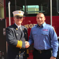 <p>Westport Fire Chief Robert Yost congratulates Nicholas Marenna, who graduated from the Connecticut Fire Academy.</p>