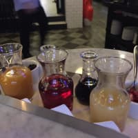<p>A tray of three fruit purees and juices, two liqueurs and two garnishes are part of the new Prosecco Bar at Frankie &amp; Fanucci’s Wood Oven Pizzeria in Mamaroneck.</p>