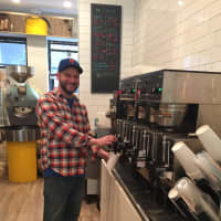 <p>Co-Owner John Minotti in the newly revamped Sunshine Coffee Roasters in Larchmont.</p>