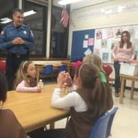 <p>Brian Linden takes questions from the Brownie Troop.</p>