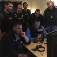 <p>Fairfield Police observe suspects involved with the production of “Hansen vs. Predator&quot; on television monitors last week.</p>