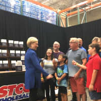 <p>Hillary Clinton greets the first two families in line at her book signing Saturday at Costco in Brookfield.</p>