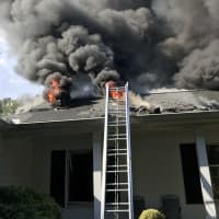 <p>The fire breaks through the roof of the home at 298 Saugatuck Ave. in Westport.</p>