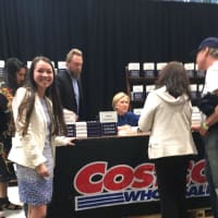 <p>Alexandra Prendergast, 19, a Danbury High grad and sophomore at Wesleyan University, waits for her parents, Sandra and Jeff, as they get their books signed by Hillary Clinton.</p>