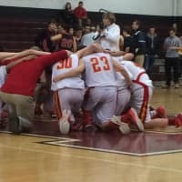<p>Frank Muggeo (red shirt) prays with his team at center court after winning the Freshman County Basketball Championship v. Northern Highlands at Ridgewood High School.</p>