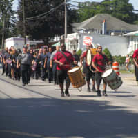 <p>A marching band performs at the Peekskill July 4th parade.</p>