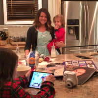 <p>Iris Tirri in her Edgewater kitchen with her three children.</p>
