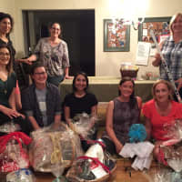 <p>Members of Women For Progress gather to put together baskets for their Sweets for Syria fundraiser.</p>