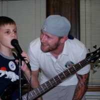 <p>Sean Yocum (right) works with a young guitarist/vocalist.</p>