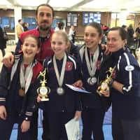 <p>Darien YMCA Level 4 gymnasts Maggie Russell, Alison Enters and Sofia Imbrogno celebrate their success at the 2016 State Championships with coaches Anatolie Vartosu and Erin Hunter.</p>