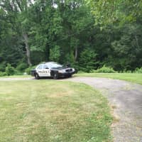 <p>A Norwalk police cruiser is behind Roton Middle School as the search continues Friday for an elderly man who attacked a teenage girl.</p>