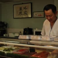 <p>Tai Mun continues to work at his 18-year-old business, Sushi Palace, on Anderson Avenue. </p>