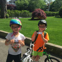 <p>Greta, 8, and Will, 6, Norman of Larchmont bike smart with their helmets.</p>