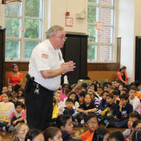 <p>Police Chief Keith M. Bendul addresses students during the Cop Cards assembly at Fort Lee Elementary School No. 4 on Oct. 2.</p>