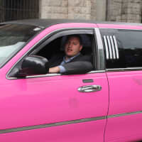 <p>Josh Schnee, owner of Advanced Car Service, behind the wheel of the pink limo.</p>