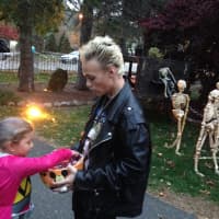 <p>Charlie Ackerson hands out candy to trick-or-treaters.</p>