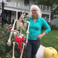 <p>Ellyn Ward and one of her many Halloween decorations.</p>