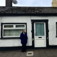 <p>Kathleen Graham of Paramus stands outside of the cottage in Southern Ireland where her mother was born and raised.</p>