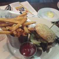 <p>The burger at Cedar Street Grill in Dobbs Ferry comes with Cabot white cheddar, in-house maple bacon, onion, jam and B&amp;B pickles.</p>
