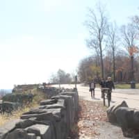 <p>Walkers enjoy the views near Stateline Lookout at Palisades Interstate Park in Alpine. </p>