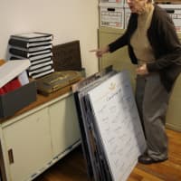 <p>Cathy Eisler of Church of the Epiphany in Cliffside Park is sorting through photos ahead of the 2016 centennial. </p>